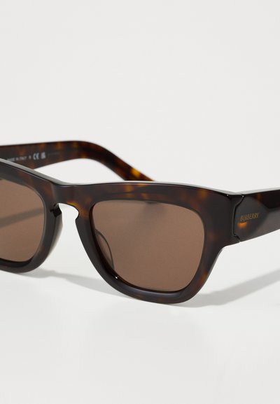 Tortoiseshell sunglasses with brown lenses, featuring a thick frame and angular design. Includes subtle "Burberry" branding on the temple.