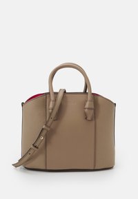 Beige nahkalaukku, jossa on rakenteellinen muotoilu, varustettuna kahdella yläkahvalla, irrotettavalla hihnalla ja kontrastivärisellä punaisella sisätilalla.