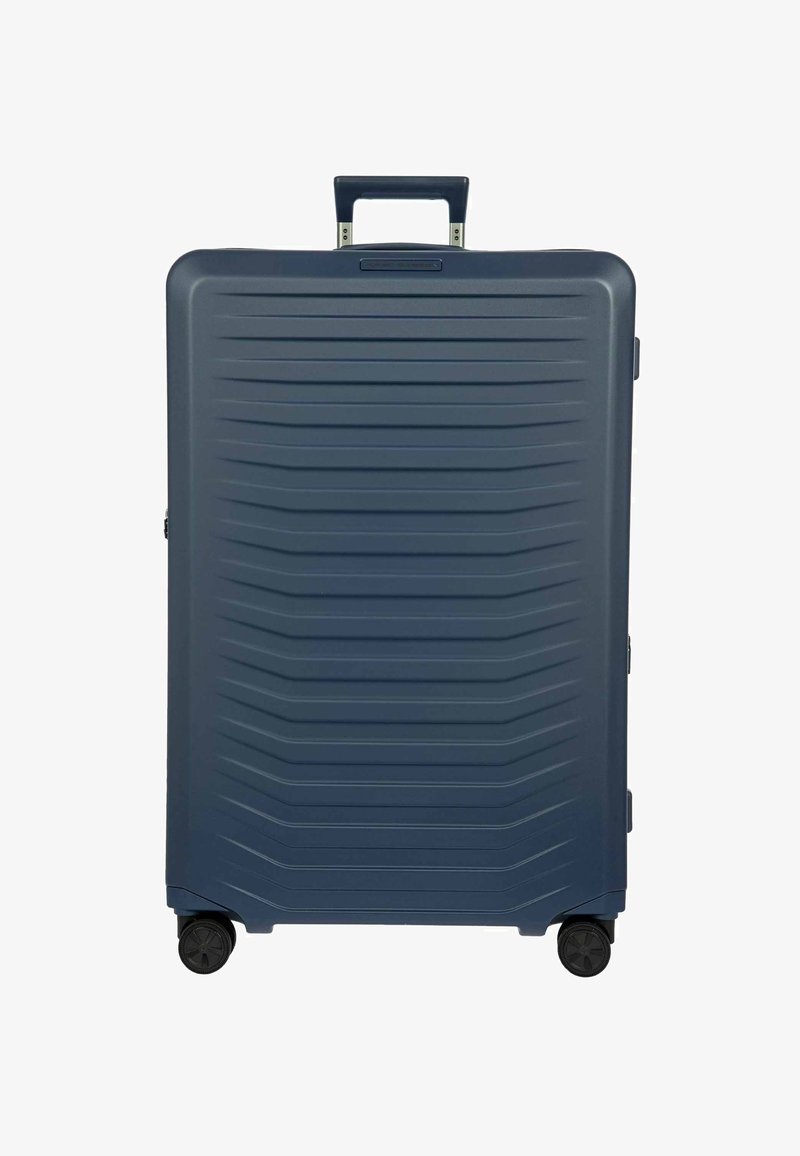 Dunkelblauer Hartschalenkoffer mit strukturierten horizontalen Rillen, vier Rollen und einem teilweise ausgezogenen Teleskopgriff.
