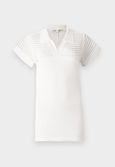 Balts polo krekls ar īsām piedurknēm, sagatavots ar teksturētu augšdaļu un gludu apakšdaļu. Izstrādāts ar klasisku apkakli un "v"-veida kakla izgriezumu.