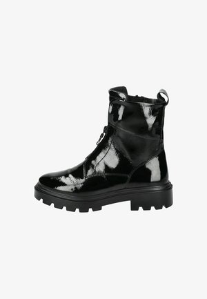 Black ankle boots made of glossy patent leather, featuring a zip closure, chunky rubber sole, and a pull tab at the back.