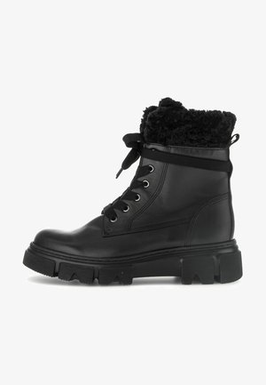 Bottines en cuir noir avec un col en fausse fourrure, bout rond et semelle en caoutchouc épaisse. Comprend des œillets en métal et un système de laçage.