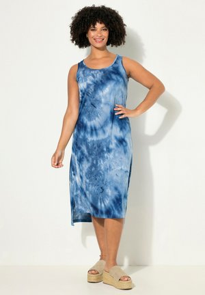 Modré tie-dye midi šaty s kulatým výstřihem a bezrukávovým designem. Mají pohodlný střih a postranní rozparky pro volnost pohybu. V kombinaci s platformovými sandály.