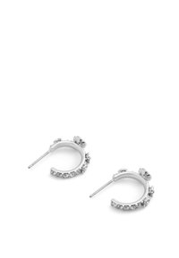Silver hoop earrings featuring a floral design accent with clear crystal embellishments along the bottom edge. Smooth finish, lightweight.