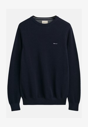 Pullover in maglina blu navy con un motivo testurizzato, scollo rotondo, polsini e orlo a coste, con un piccolo logo bianco sul petto.