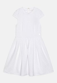Robe blanche à manches courtes avec un motif texturé, jupe évasée et fermeture éclair au dos. Un petit accent décoratif est présent sur le côté.