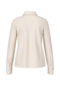 Cream-colored long-sleeve shirt with a collar, featuring a smooth texture and buttoned cuffs. The back is simple and unembellished.