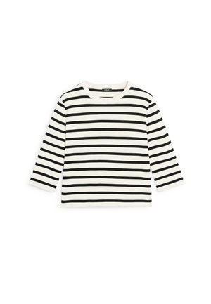 Top à manches longues rayé en crème avec des rayures horizontales noires, fabriqué en tissu de coton ; il dispose d'un col rond et d'une coupe décontractée.
