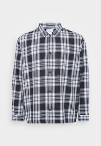 Black and white plaid button-up shirt, featuring a standard collar, long sleeves, and a chest pocket. Soft fabric with a smooth texture.