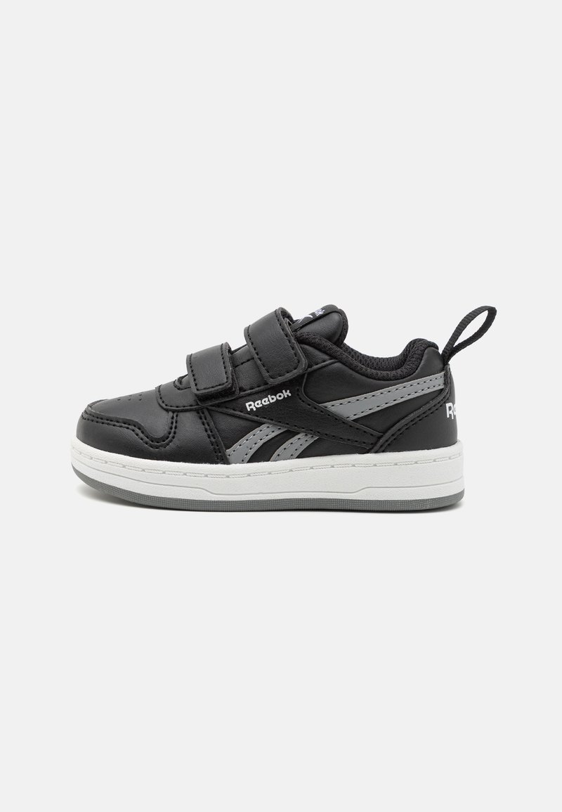 Black leather sneakers with two Velcro straps, gray accents, white midsole, and a loop tab at the back for easy wear.
