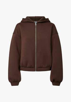 Rjava zip-up kapuca, izdelana iz teksturirane tkanine. Ima kapuco, padajoče ramena ter elastične manšete in rob za sproščen fit.