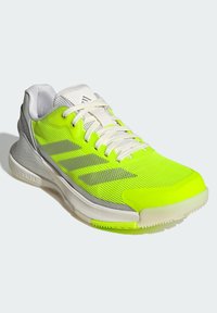 Neon yellow athletic shoe with mesh upper, grey accents, white laces, and a cushioned sole. Features three stripes logo on the side.