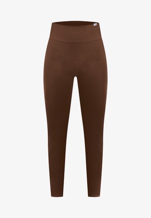Leggings marron avec une taille haute sans couture, fabriqués dans un matériau lisse et extensible. Le design est ajusté de la taille à la cheville.