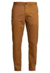 Pantalons en coton marron à coupe droite, fermeture à un bouton, poches avant et texture lisse. Design minimaliste sans motifs visibles.