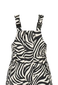 Zwart-witte overal met zebrapatroon, voorzien van verstelbare bandjes, twee voorzakken en een knoopsluiting. Gemaakt van lichtgewicht stof.