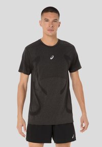Black athletic t-shirt with short sleeves, featuring a textured design and a white logo on the chest. Made from moisture-wicking material.