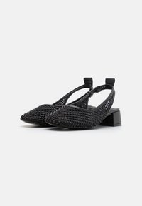 Black slingback shoes with a pointed toe, textured mesh upper, and small block heel. Accented with small, shiny details throughout.