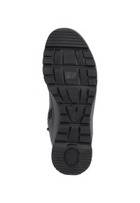Black rubber sole with textured tread patterns, featuring branding and a circular accent. Flexible material designed for comfort.