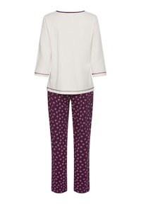 Cotton pajama set featuring a cream top with three-quarter sleeves and a round neck, paired with purple pants adorned with white heart patterns.