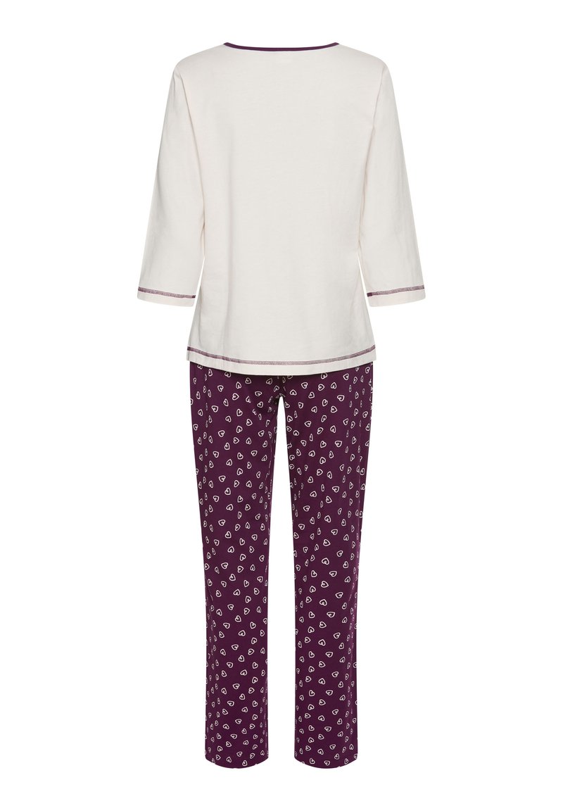 Cotton pajama set featuring a cream top with three-quarter sleeves and a round neck, paired with purple pants adorned with white heart patterns.