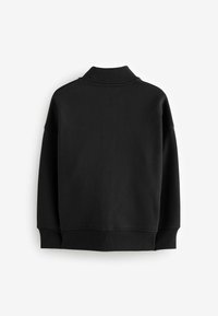 Felpa nera oversize con colletto alto, polsini e orlo a costine. Texture liscia, spalle senza cuciture e design minimalista.
