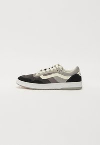 Sneakers with a mix of suede and textile materials in gray, black, and white. Features a padded collar, white laces, and logo detail.