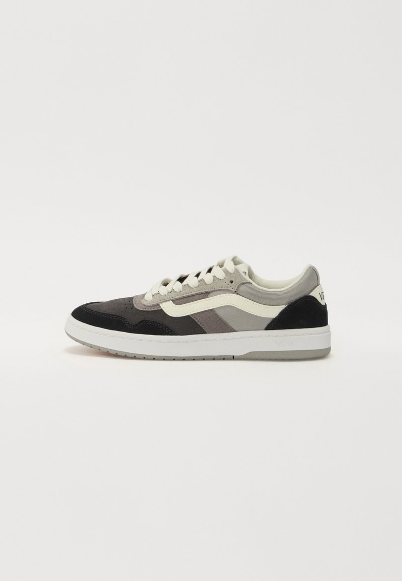 Sneakers with a mix of suede and textile materials in gray, black, and white. Features a padded collar, white laces, and logo detail.