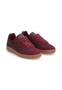 Burgundy sneakers with a suede upper, glittery accents, flat laces, and a gum rubber sole. Designed with a sleek silhouette and textured panels.