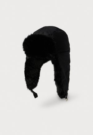 Black winter trapper hat with faux fur lining and ear flaps, featuring a chin strap and metallic buckle.
