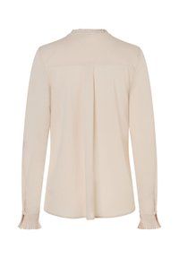 Hellbeige Bluse mit langen Ärmeln, plissiertem Rückendetail und Knopfmanschetten. Weicher Stoff mit feiner Textur und gerafftem Ausschnitt.