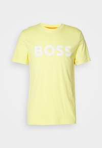 Yellow short-sleeve T-shirt with round neck and large white text "BOSS" printed across the chest.