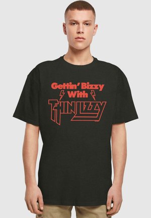 Black cotton t-shirt featuring bold red text stating "Gettin' Bizzy With Thin Lizzy," with lightning bolt accents. Relaxed fit, crew neckline.