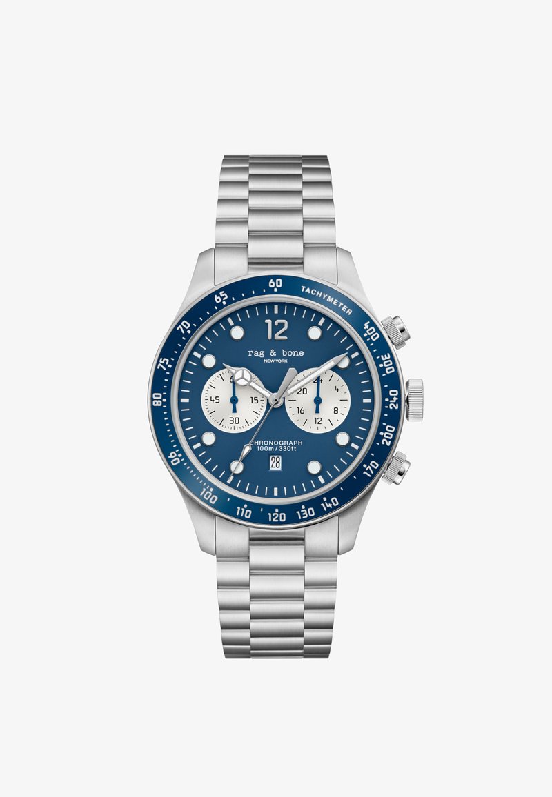 Roostevabast terasest kronograafkell sinise kellanäidiku, valgete aladialkide, hõbedaste aktsentide ja lingiga rihmaga. Veekindel kuni 100 m.