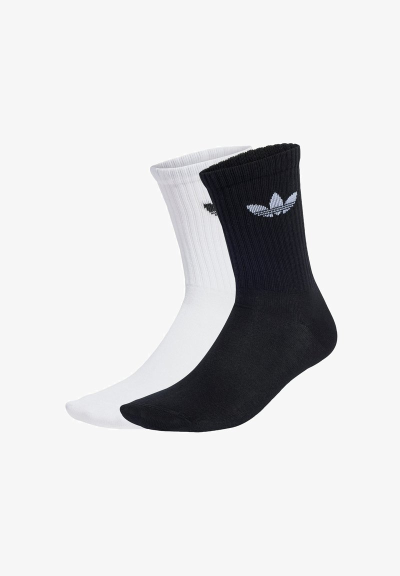 Calcetines deportivos en blanco y negro con diseño acanalado y logotipo bordado en el puño; mezcla de algodón, longitud hasta el tobillo, construcción de punta sin costuras.