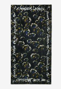 Sciarpa nera con un motivo floreale in bianco, viola e verde, con testo scritto a mano lungo i bordi. Il testo contrasta con lo sfondo.