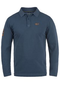 Polo majica dugih rukava u tamnoplavoj boji od pamuka s tri gumba i izvezenim logom. Sadrži dekorativnu aplikaciju na rukavu.