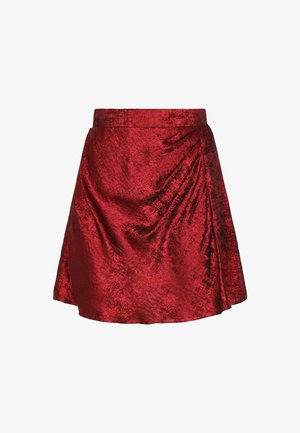 Roter Rock aus glänzendem Stoff mit Wickeldesign. Er hat eine ausgestellte Form, eine glatte Textur und einen Taillenbund.