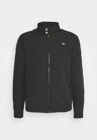 Zwarte geborduurde jas met een hoge kraag, ritssluiting aan de voorkant, twee drukknoopjes en een klein logo op de linkerborst. Zacht, textuur materiaal.