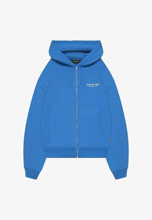 Blauwe ritshoodie van zachte katoen. Heeft een voorzak, een capuchon met trekkoord en een geborduurd logo op de linkerkant van de borst.