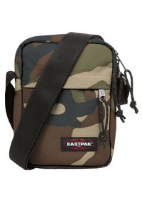 Borsa a tracolla mimetica realizzata in tessuto resistente, dotata di una tasca frontale con zip, tracolla regolabile e etichetta con il logo Eastpak.