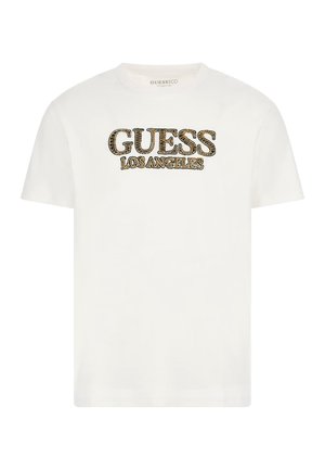 T-shirt blanc à manches courtes avec le texte "GUESS LOS ANGELES" en motif léopard sur le devant.