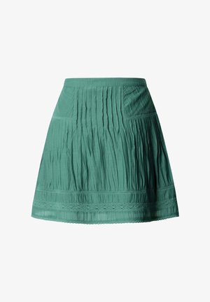 Gonna verde al ginocchio con pieghe e dettagli in pizzo lungo l'orlo e la parte centrale, con una cintura piatta.