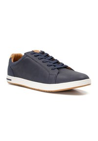 Navy leather sneakers with white rubber soles, featuring round toe, stitched detailing, and blue laces and tan inner lining.