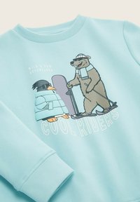 Lichtblauwe sweatshirts met cartoonafbeeldingen van een pinguïn en een beer, met de tekst "COOL RIDERS." Zachte stof, ribbelmanchetten en -kraag.
