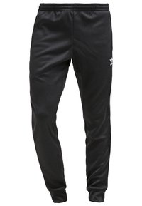 Svarta träningsbyxor med en slät, syntetisk textur, med vita sidostrecker och en broderad logotyp på vänster höft. Elastisk midja.