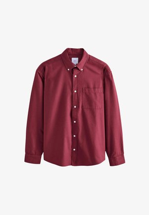 Burgundin pitkähihaine nappipaitaus, jossa on yksi rintatasku, kaulus ja valkoiset napit. Pehmeä rakenne, istuva malli.