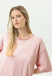 Randig rosa t-shirt med korta ärmar och rund halsringning. Mjukt tyg med subtil textur. Har en kontrasterande kant runt halsringningen.