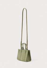 Small olive green handbag with short handles and a long adjustable shoulder strap against a plain white background.