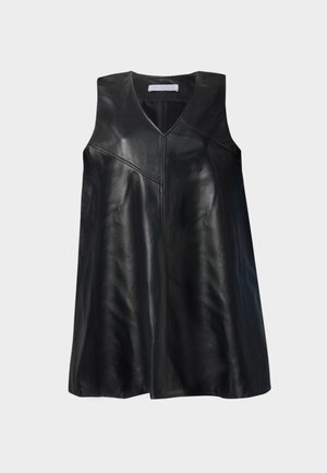 Black sleeveless leather dress with V-neck and asymmetrical seam detailing, knee-length, displayed against a white background.
