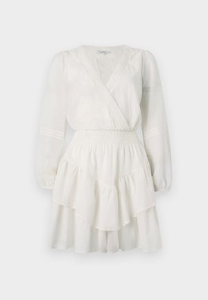White, tiered dress with a deep V-neckline, long sleeves, and a smocked waistband. The fabric appears lightweight and flowy.